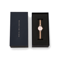 Petite Mini Blush Melrose watch with a blush pink dial and rose gold mesh strap, presented in a sleek Daniel Wellington gift box.