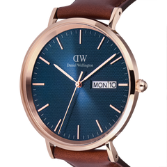 Close-up of the Classic Day Display St Mawes Rose Gold Arctic watch, highlighting the blue textured dial, rose gold case, and day and date window, paired with a brown leather strap.