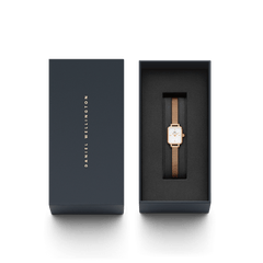 Quadro Mini Melrose watch with a rose gold mesh strap and rectangular white dial, elegantly presented in a branded Daniel Wellington gift box.
