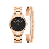 Rose gold Daniel Wellington Iconic Link Black watch with a black dial and matching rose gold link strap, paired with a minimalist rose gold Elan Bracelet featuring subtle engraved branding.