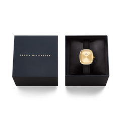 Margot Sheffield Unitone Sunray Gold ladies watch with a rectangular gold case and black leather strap, presented in a Daniel Wellington gift box.