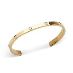 Classic Lumine Bracelet Gold 55mm shown at an angle, highlighting its slim open cuff design, polished gold finish, and eight sparkling cubic zirconia stones set evenly along the band.
