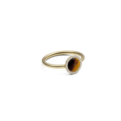 Audrey Ring Tiger Eye Gold featuring a slim gold band, oval tiger eye gemstone, and a halo of white cubic zirconia crystals, highlighting its elegant and modern design.