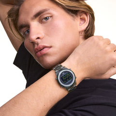 A person wearing the Retro Digital Dark Green watch, featuring a dark green transparent link bracelet and round black digital dial, styled with a casual black t-shirt.