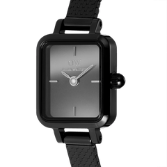 Close-up of the Quadro Mini Reflection Black watch highlighting its rectangular mirror-effect black dial, minimalist hour markers, and slim black mesh strap for a sleek, contemporary style.