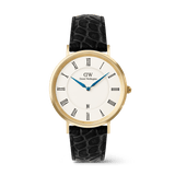 Men’s gold Daniel Wellington Classic Roman Numerals Date watch with a white dial, black Roman numeral markers, blue hands, date display at six o’clock, and a black croc-embossed leather strap.