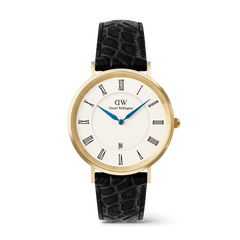 Men’s gold Daniel Wellington Classic Roman Numerals Date watch with a white dial, black Roman numeral markers, blue hands, date display at six o’clock, and a black croc-embossed leather strap.