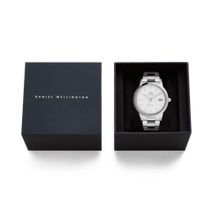 Daniel Wellington Iconic Link Automatic Silver men’s watch with a stainless steel bracelet, presented in a branded gift box with the lid beside it.