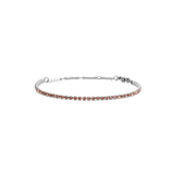A slim silver tennis bracelet featuring apricot-coloured crystals set along a delicate chain, with an adjustable clasp for a comfortable fit.