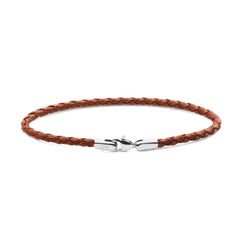 Slim braided tan leather bracelet with a polished silver clasp, showcasing a minimalist and versatile design suitable for men’s everyday wear.