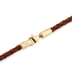 Detail of the Daniel Braided Leather Bracelet St Mawes 2.8 Gold, highlighting the gold-tone stainless steel lobster clasp and the slim, braided brown leather.
