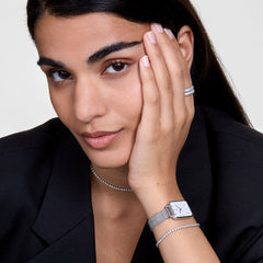 Classic Tennis Necklace Silver styled on the collarbone, paired with a silver watch, tennis bracelet, and matching rings, creating a coordinated and sophisticated look with a black blazer.