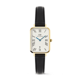 Quadro Roman Numerals Date Sheffield Gold ladies watch with a rectangular gold case, white guilloché dial featuring bold Roman numerals, blue hands, date window at 6 o’clock, and a slim black leather strap.