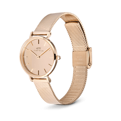 Daniel Wellington Petite Reflection Rose Gold watch with a 28mm mirror-effect dial, minimalist hour markers, and a polished rose gold mesh strap featuring an adjustable clasp.