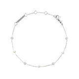 Delicate silver bracelet featuring alternating white Swarovski glass pearls and cubic zirconia on a slim chain, with adjustable links and a secure clasp for a comfortable fit.