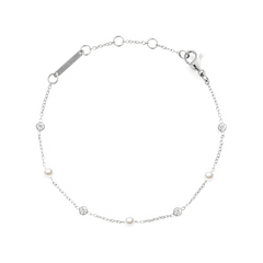 Delicate silver bracelet featuring alternating white Swarovski glass pearls and cubic zirconia on a slim chain, with adjustable links and a secure clasp for a comfortable fit.