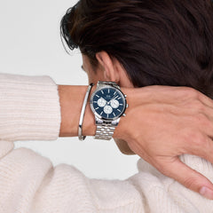 Iconic Chronograph Arch 5-Link Arctic Panda Silver men's watch with a blue dial and silver sub-dials, worn on the wrist with a silver bracelet and paired with a cream knit jumper.