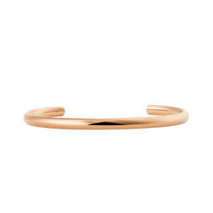 Slim rose gold cuff bracelet with a softly rounded, minimalist design and a polished finish, featuring an open-ended adjustable style suitable for everyday wear.