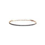 Slim rose gold tennis bracelet featuring a single row of dark Preciosa crystals, with an adjustable chain and lobster clasp for a comfortable, elegant fit.