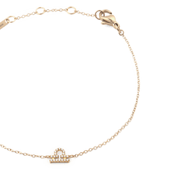 Close-up of the Crystal Zodiac Chain Bracelet Gold, showing the fine gold chain, adjustable sizing rings, and a sparkling Libra zodiac charm set with crystals.