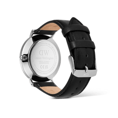 The back view of the Classic Day Display Sheffield Silver watch highlights the engraved stainless steel case, genuine black leather strap, and secure tongue buckle closure.