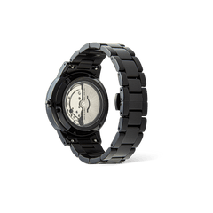 Daniel Wellington Iconic Link Automatic Black men’s watch showing the exhibition case back, revealing the automatic movement and solid black stainless steel link bracelet.
