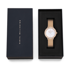 Crystalline Bezel Melrose rose gold ladies watch with a crystal-set bezel and mesh strap, elegantly presented in a black Daniel Wellington gift box.