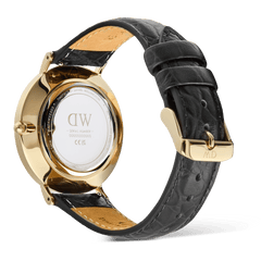 Rear view of the Daniel Wellington Classic Roman Numerals Date Black Croc Belly Gold men’s watch, showing the gold case, engraved case back, and black croc-embossed genuine leather strap with gold buckle.