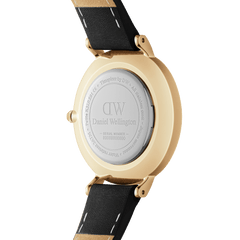 Back view of the Petite Roman Numerals Sheffield Gold watch showing the engraved stainless steel case, gold-plated finish, and black genuine leather strap with stitched detailing.