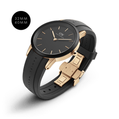Daniel Wellington Iconic Motion Rose Gold watch in 32mm and 40mm sizes, featuring a rose gold stainless steel case, minimalist black dial with rose gold markers, and a black FKM rubber strap with a butterfly clasp.