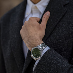 Iconic Link Emerald Green Silver watch with a stainless steel bracelet and emerald green dial, worn with a formal dark coat and white shirt for a sophisticated, modern look.