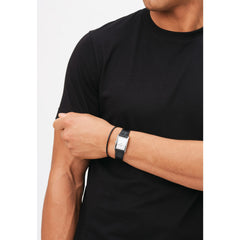 Bound Black Crocodile Silver watch worn on the wrist, featuring a rectangular silver case, white dial, and black crocodile-embossed leather strap, styled with a black t-shirt for a modern and understated look.