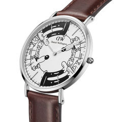 Daniel Wellington Bristol BW dial watch from the Steven Harrington collaboration, featuring a stainless steel case, brown Italian leather strap, and distinctive black and white psychedelic artwork on the dial.
