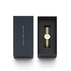 Elan Lumine Gold ladies watch with a white crystal-accented dial and gold three-link bracelet, elegantly presented in a Daniel Wellington branded gift box.