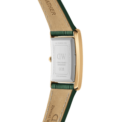 Close-up of the Bound Crocodile Champagne Sunray Gold watch showing the stainless steel case back, gold rectangular frame, and green crocodile-pattern genuine leather strap with visible stitching.