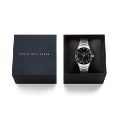 Iconic Paradigma Link Black Enamel watch with a silver stainless steel bracelet and black dial, elegantly presented in a Daniel Wellington gift box, ideal for gifting or adding to your collection.